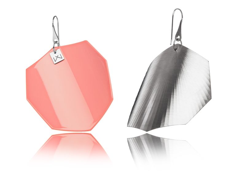 two earrings with different shapes and colors are shown on a white background, one in pink and the other in silver