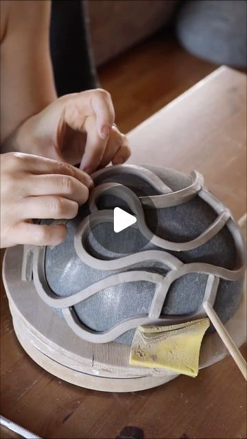 a person is working on some kind of object that looks like a vase or bowl