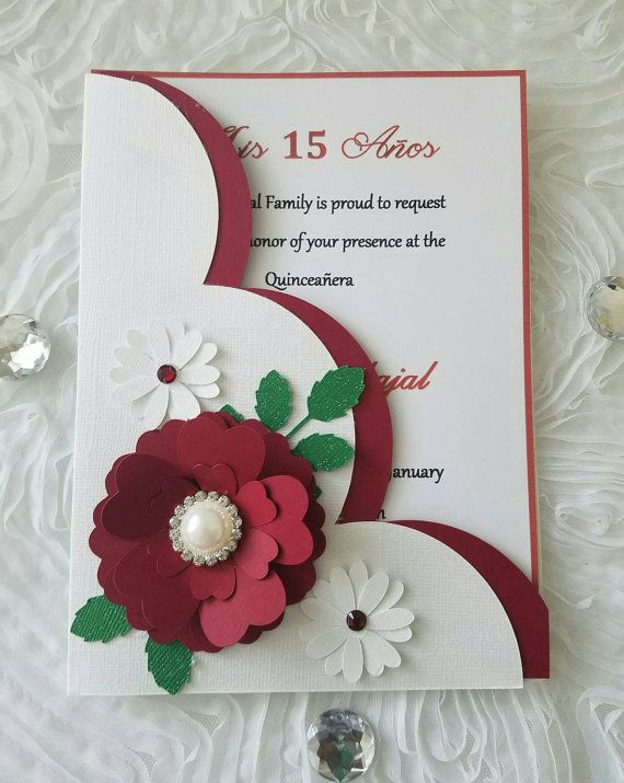 a red and white card with flowers on it