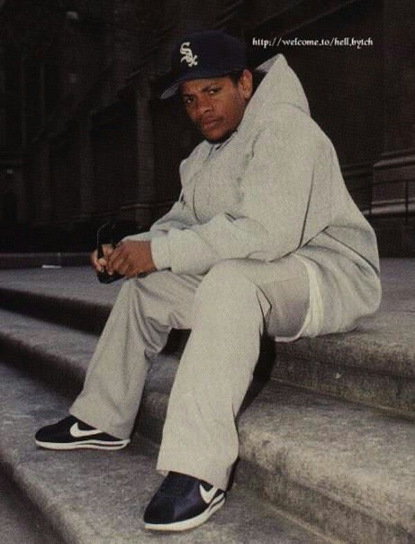 a man sitting on the steps in front of a building