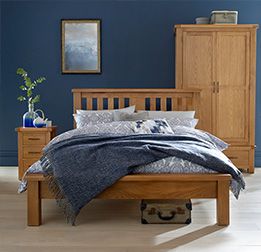 a bedroom with blue walls and wooden furniture