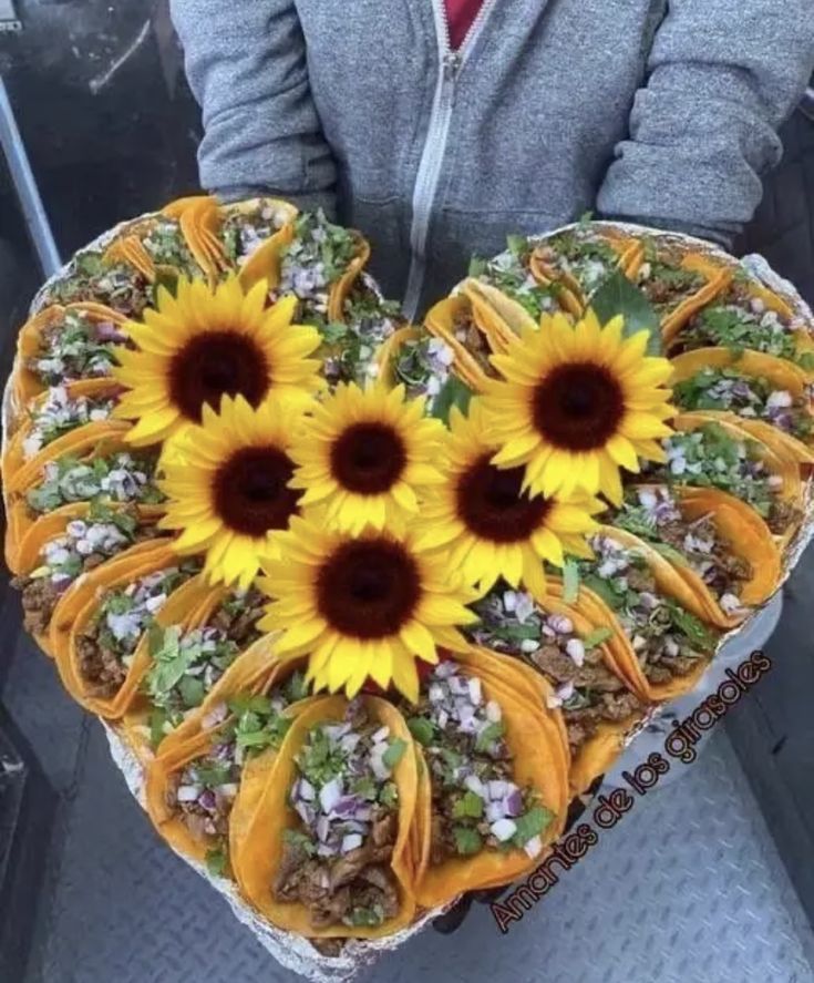 a heart shaped cake with sunflowers on it