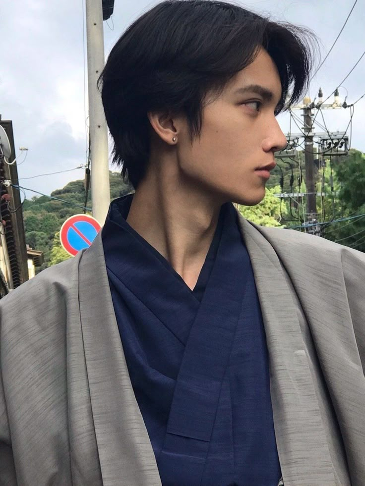 a man with black hair wearing a kimono