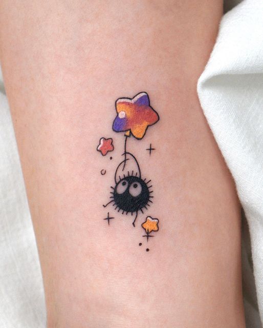 a tattoo on the leg of a woman with an orange and purple balloon attached to it