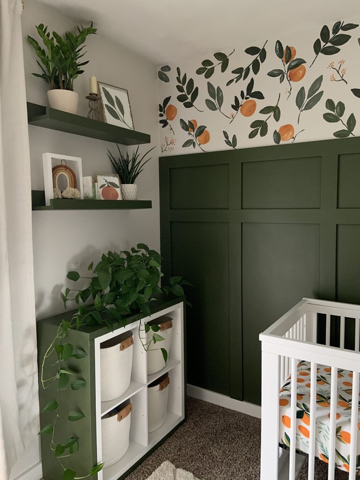 a baby's room decorated in green and white