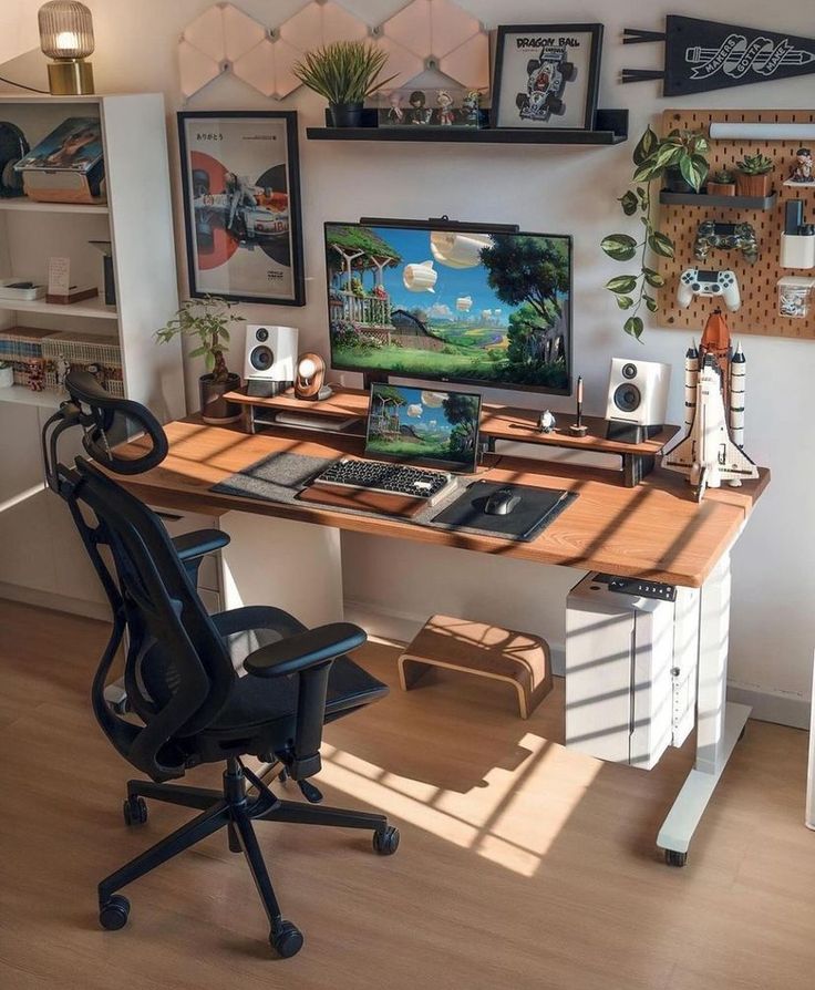 a desk with a computer on top of it in front of a wall filled with pictures