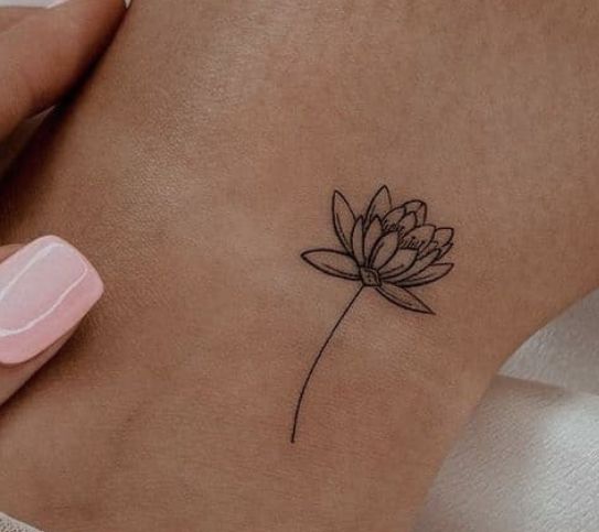 a small flower tattoo on the ankle