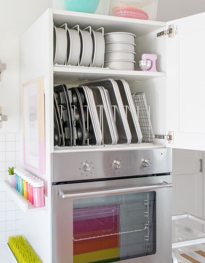 an oven with dishes and pans on it's shelves in a kitchen area