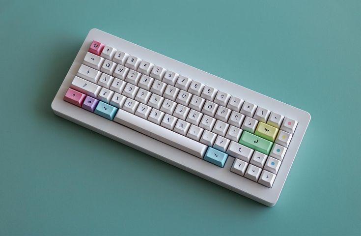 a computer keyboard sitting on top of a blue table next to a green wall and floor