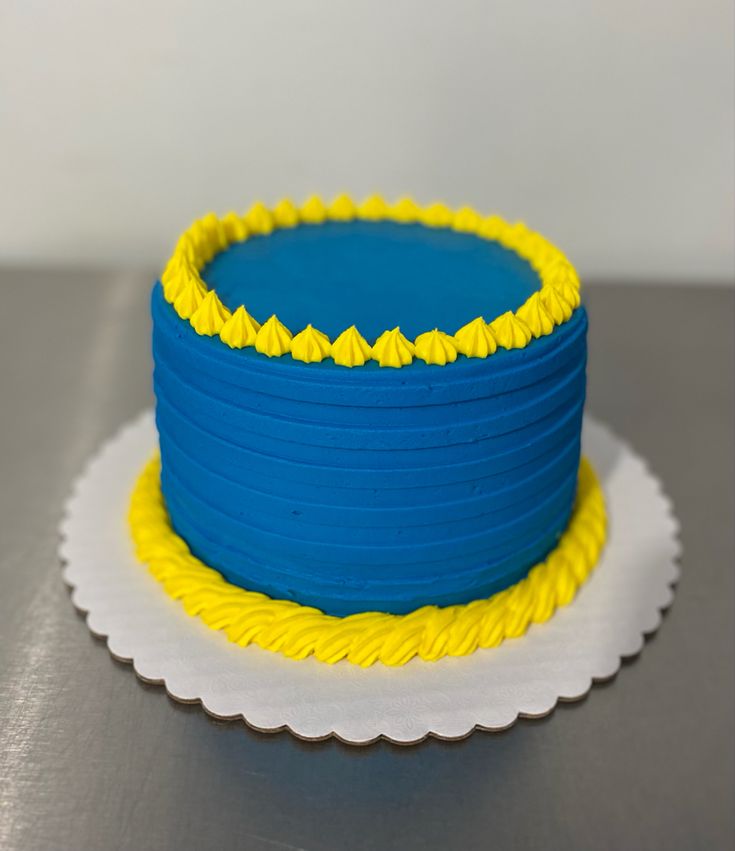 a blue and yellow cake sitting on top of a table