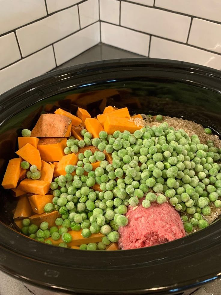 peas, carrots and meat in a slow cooker