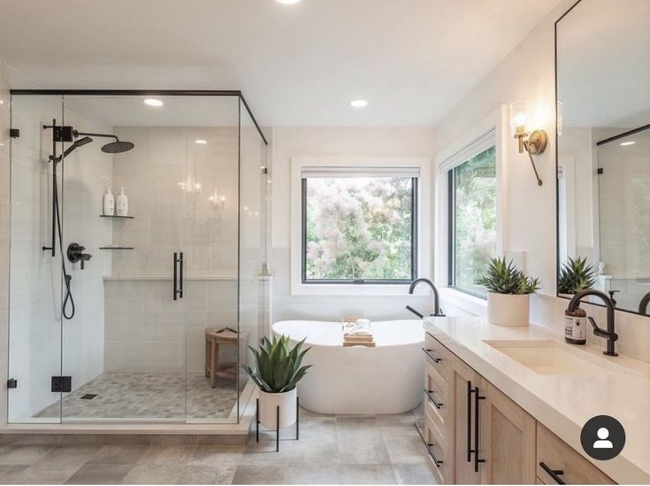 a bathroom with a tub, shower and sink