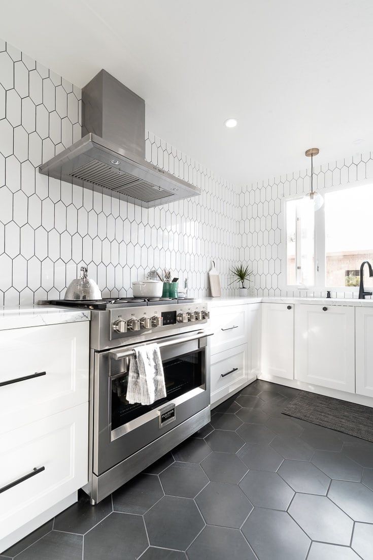 the kitchen remodel before and after is complete with white cabinets, stainless steel appliances, and hexagonal tile