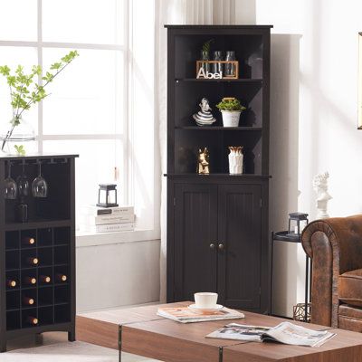 a living room filled with furniture and a wine rack on top of a coffee table