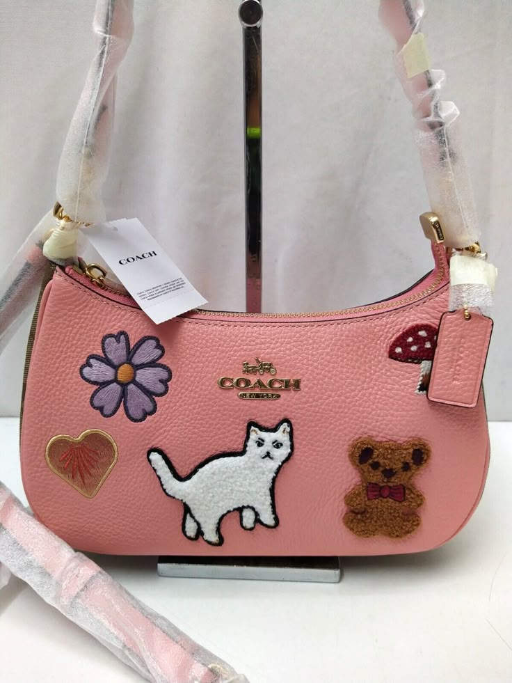 Coach Teri Candy Pink Leather with Creature Patches Crossbody Shoulder Bag 100% authentic New with tag MSRP: $425   Features: Refined pebble leather and Signature coated canvas Two credit card slots Inside multifunction pocket Zip-top closure, fabric lining Detachable handle with 8 1/4" drop Detachable strap with 22 3/4" drop for shoulder or crossbody wear 9 1/2" (L) x 6" (H) x 3" (W) Style No. CC420 Please see the images for further detail and ask any questions you may have before making a bid. Cute Coach Bags, Handbag Essentials, Girly Bags, Cute Handbags, Ebay Clothes, Fancy Bags, Cute Purses, Pretty Bags, Candy Pink