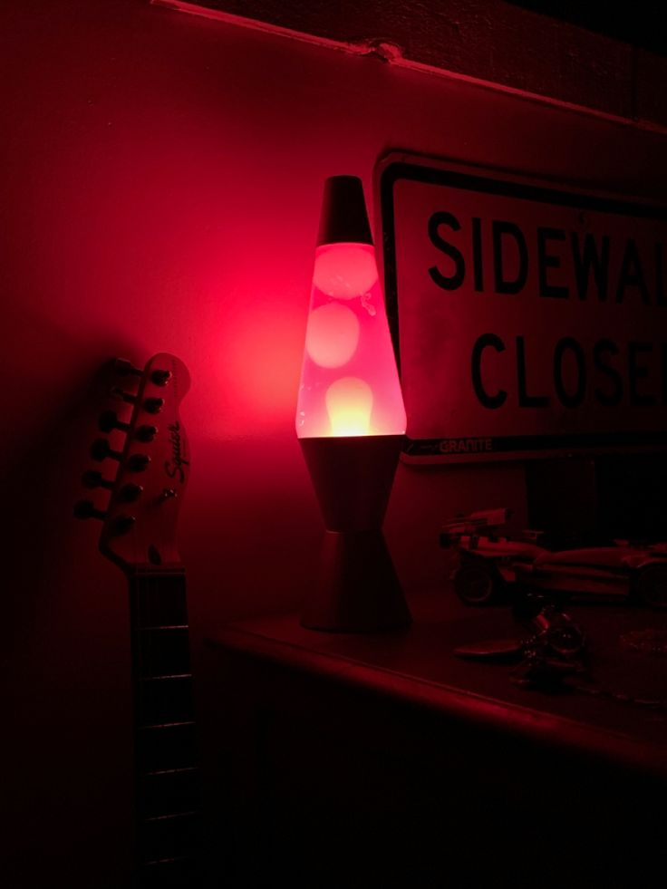 a red light shines on a table next to a sign