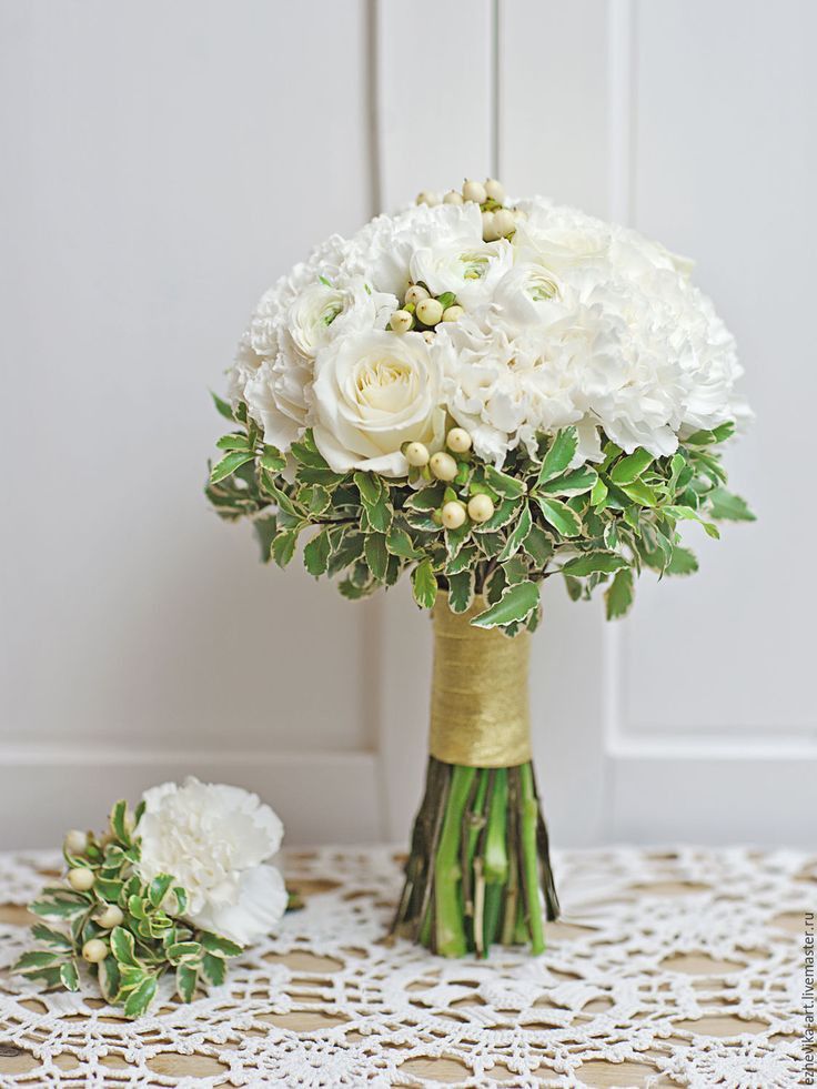 a bouquet of white flowers sitting on top of a table