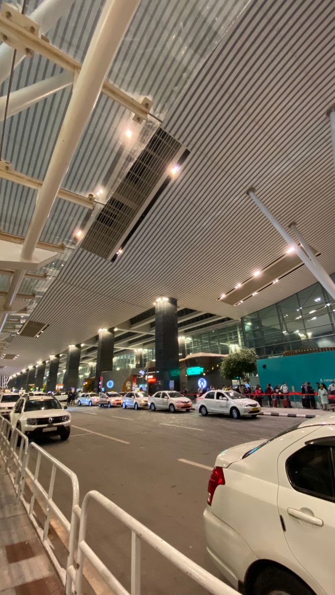 cars are parked in front of an airport terminal