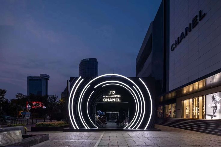 the entrance to chanel is lit up at night