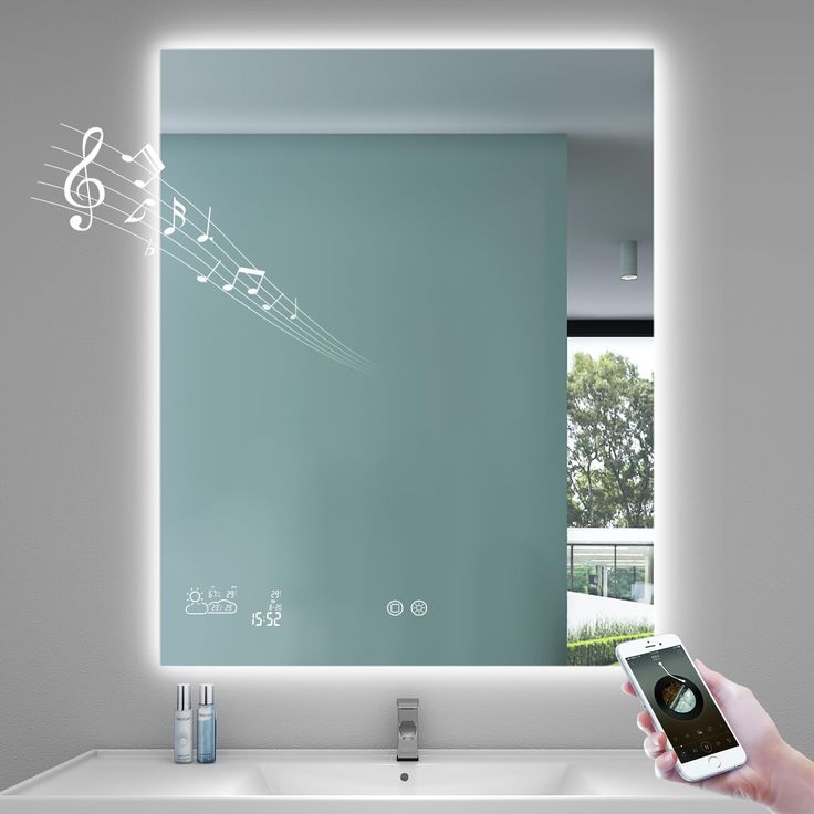 a person holding a cell phone in front of a mirror with musical notes on it