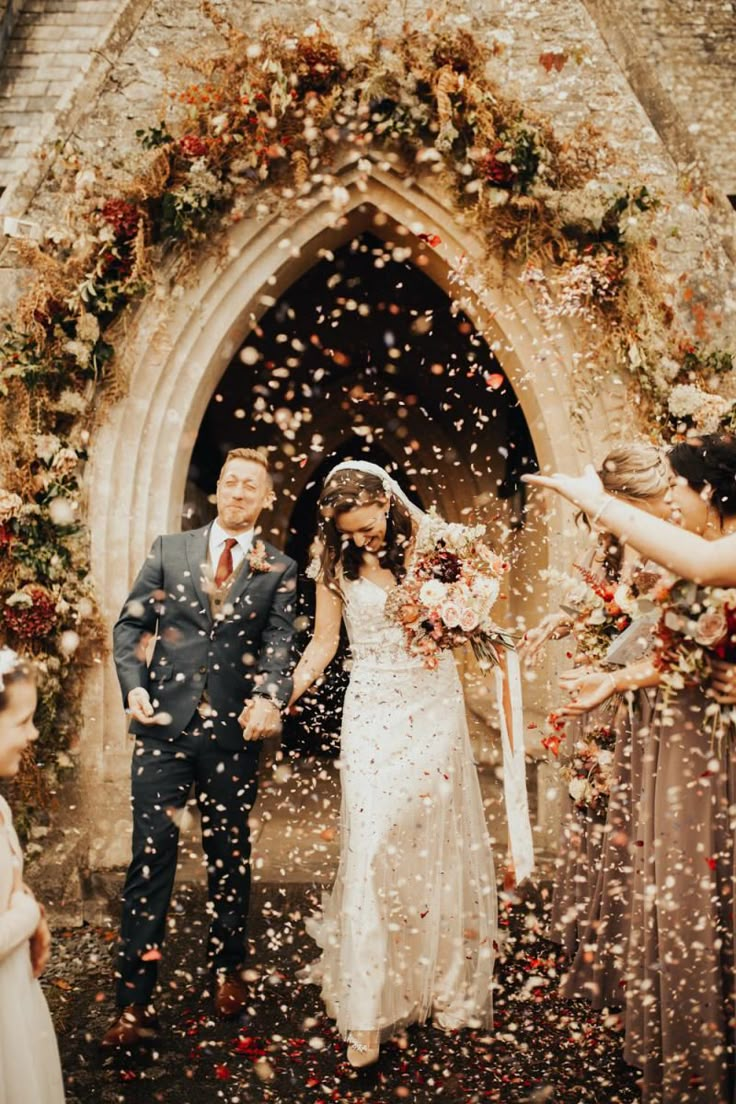 a newly married couple walking through confetti