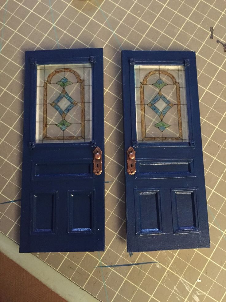 two blue doors sitting on top of a tiled floor