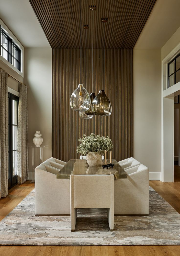 a living room with two couches and a table in front of a large window