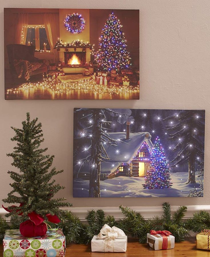 christmas decorations and presents are on the table in front of two canvass with lights