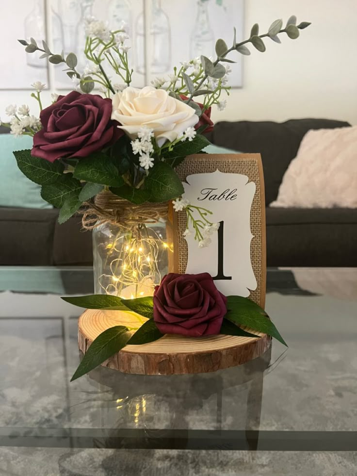 a vase filled with flowers sitting on top of a table next to a wooden slice