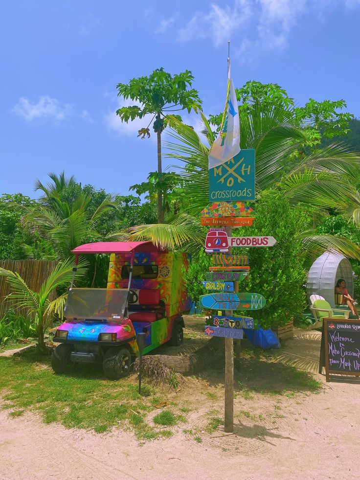 an ice cream truck is parked in front of a sign with directions to different locations