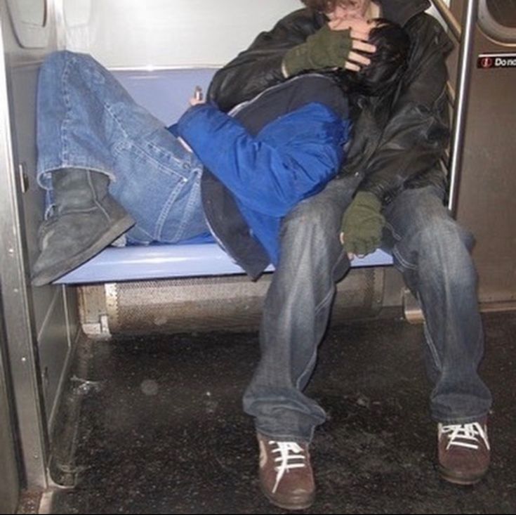 two people sitting on a bus next to each other