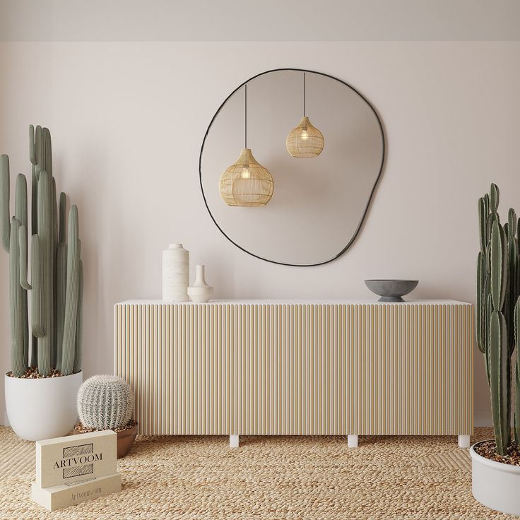 a living room with cactus plants and a round mirror on the wall above it's console table