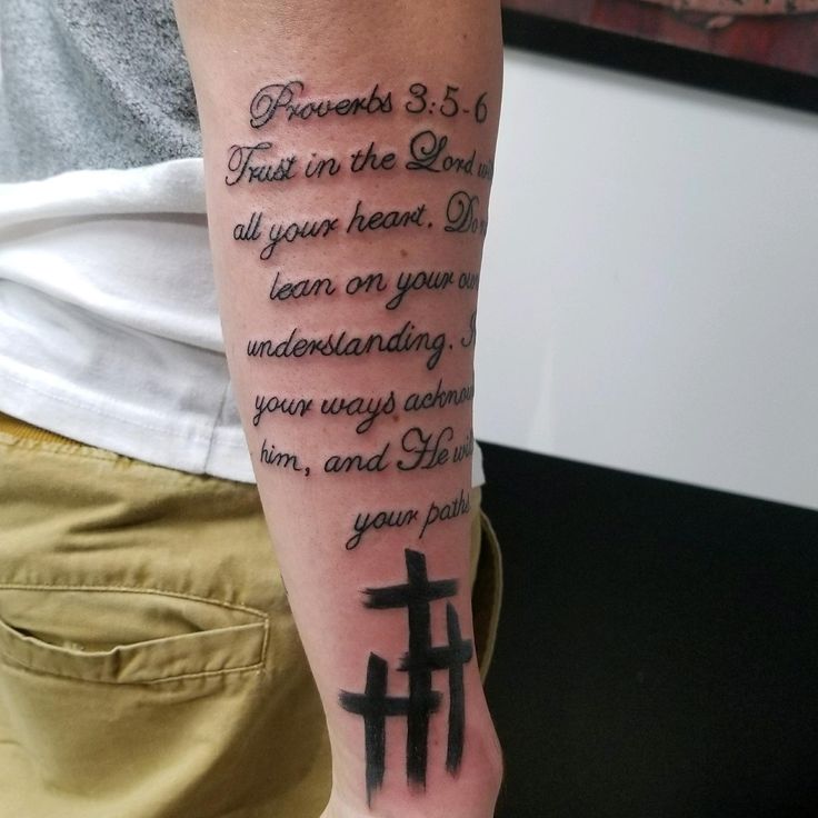 a person with a cross tattoo on their arm