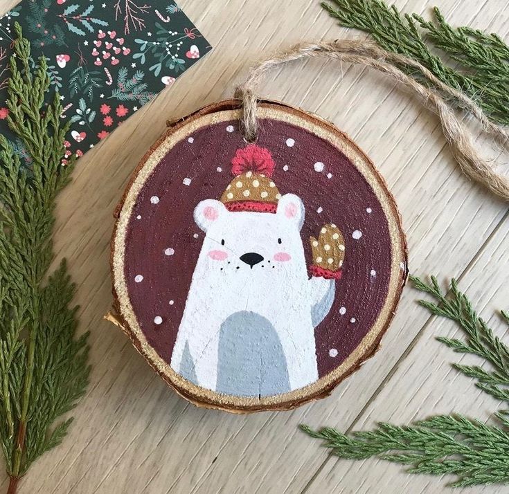 a wooden ornament with a polar bear wearing a hat on it's head