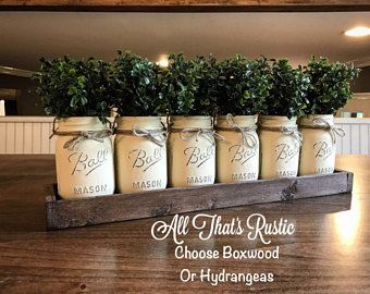 there are many mason jars with plants in them on the wooden table and above it is a sign that says, all that's rustic choose boxwood or hydrangegeas