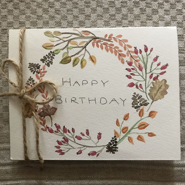 a happy birthday card with a wreath on it