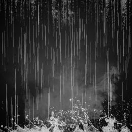 black and white photograph of rain falling down