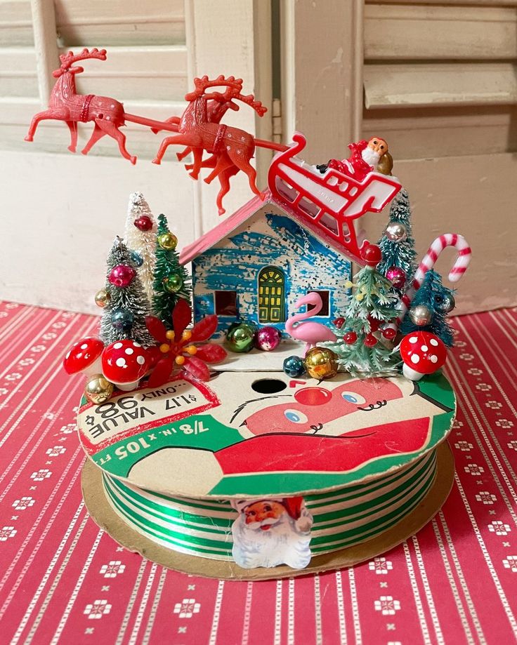 there is a santa clause on top of this christmas decoration box with his sleigh and reindeers