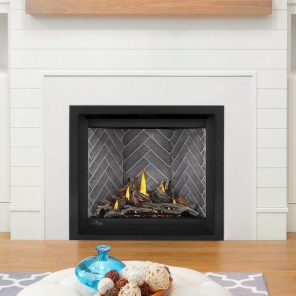 a plate with donuts on it sitting in front of a fireplace