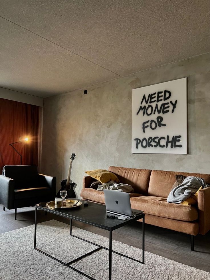 a living room filled with furniture and a poster on the wall above it that says need money for porsche