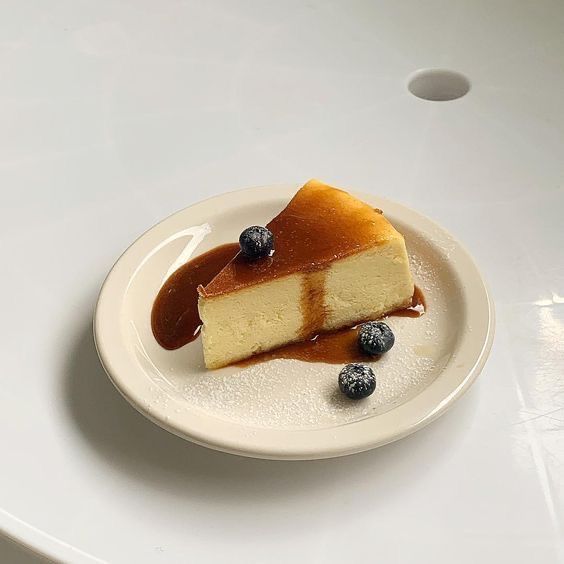 a piece of cheesecake on a plate with blueberries