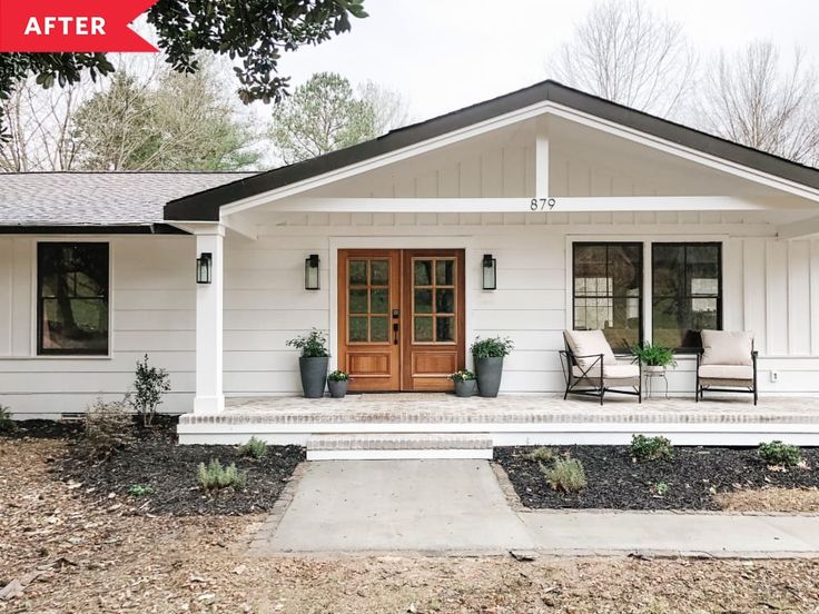 a white house with two chairs on the front porch