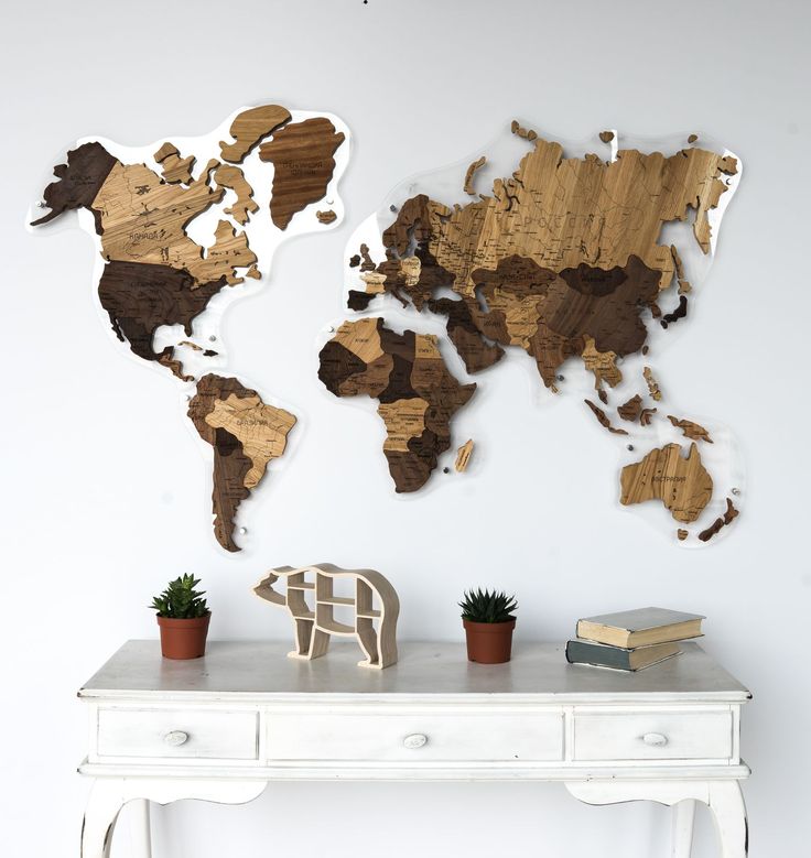 a white table topped with a wooden world map