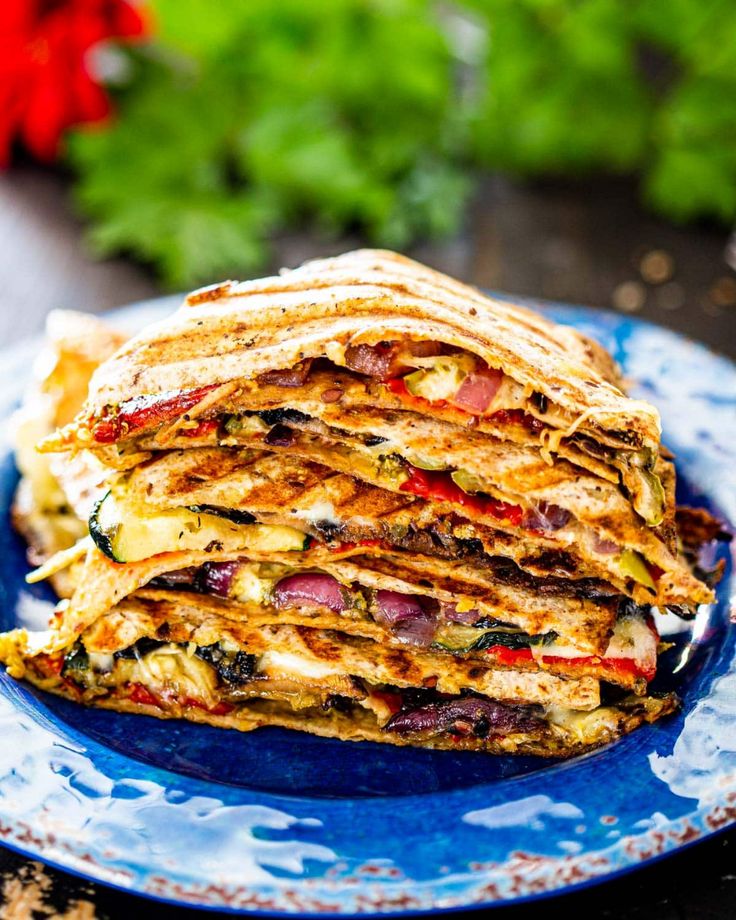 a stack of quesadilla stacked on top of each other in a blue plate