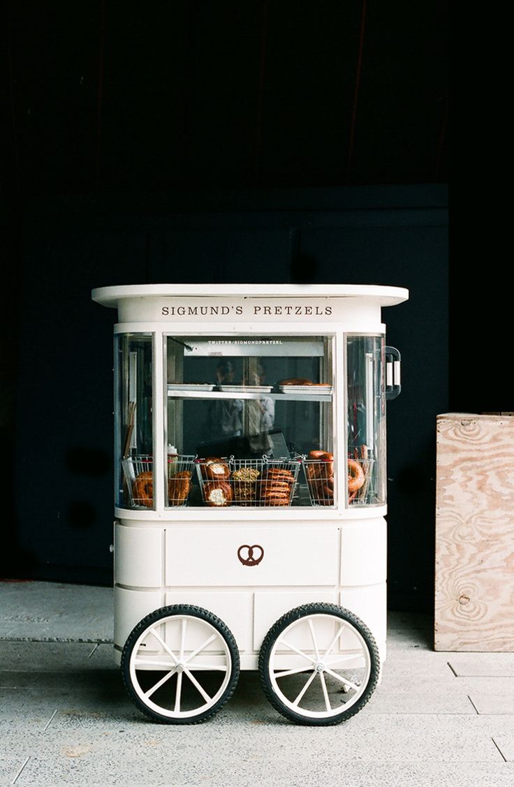 an old fashioned ice cream cart on the sidewalk