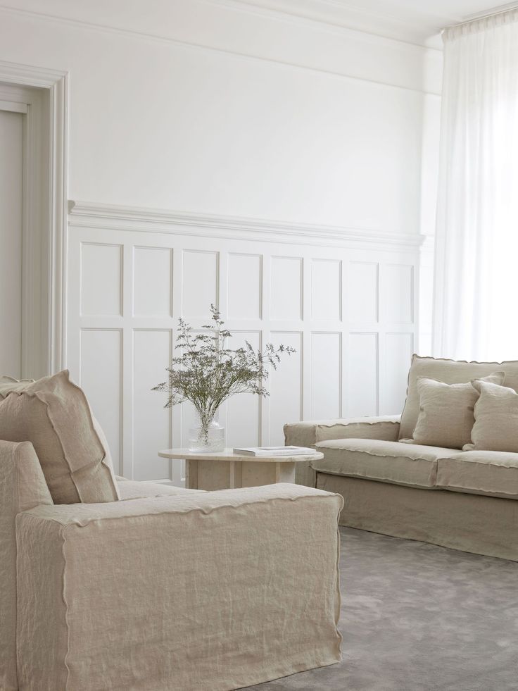 a living room filled with furniture and white walls