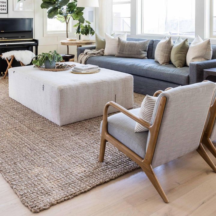 a living room filled with furniture and a piano