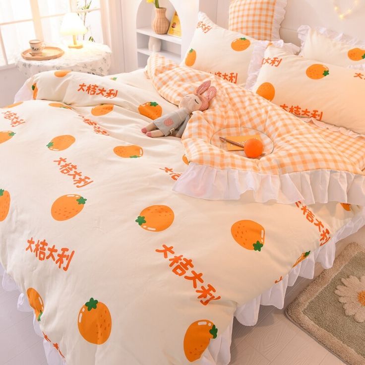 a bed with oranges and gingham on it