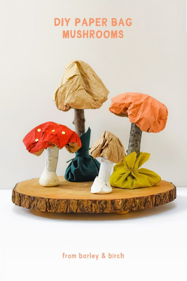 paper bag mushrooms sitting on top of a tree stump with the title diy paper bag mushrooms