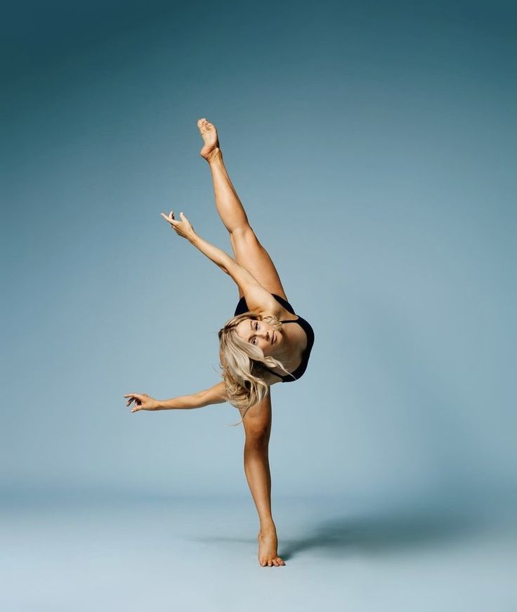 a woman is doing a handstand in the air with her legs spread out